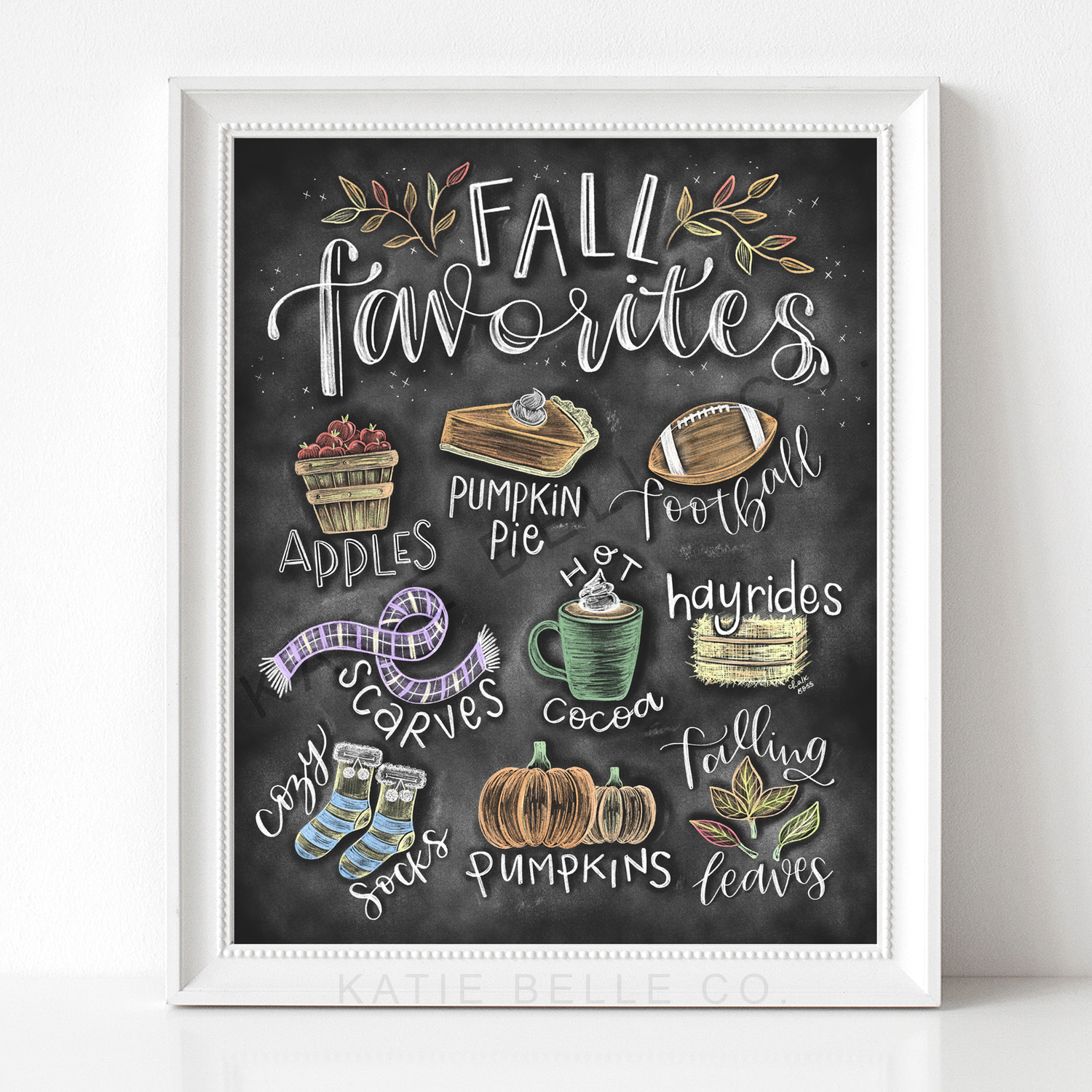 Fall favorites chalkboard print. Fall favorites hand lettered tittle. Fall doodles including apple, pumpkin pie, football, scarves, hot cocoa. hayrides, cozy socks, pumpkins, falling leaves. Fall decor. Chalk Art. Frame not included. Hand drawn by Katie Belle Co. 